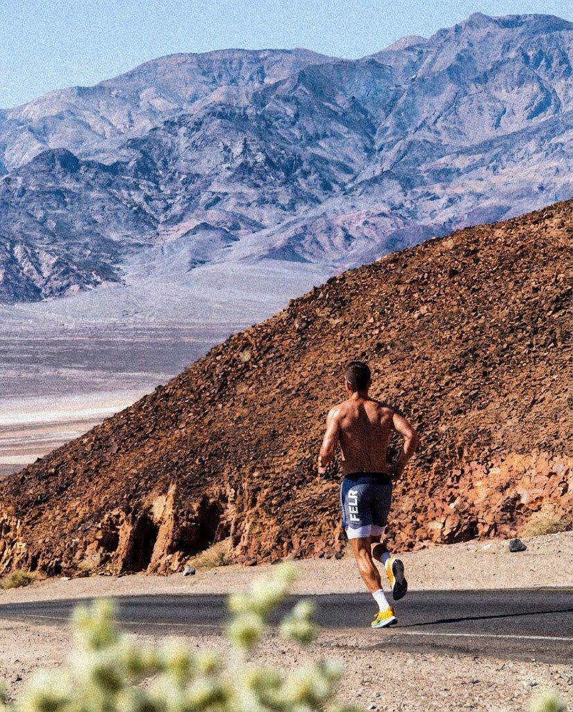 Runner in FELR shorts on a mountain road